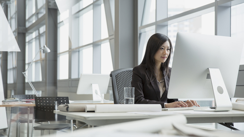 Woman at computer in office 500 x 281 Card Hero